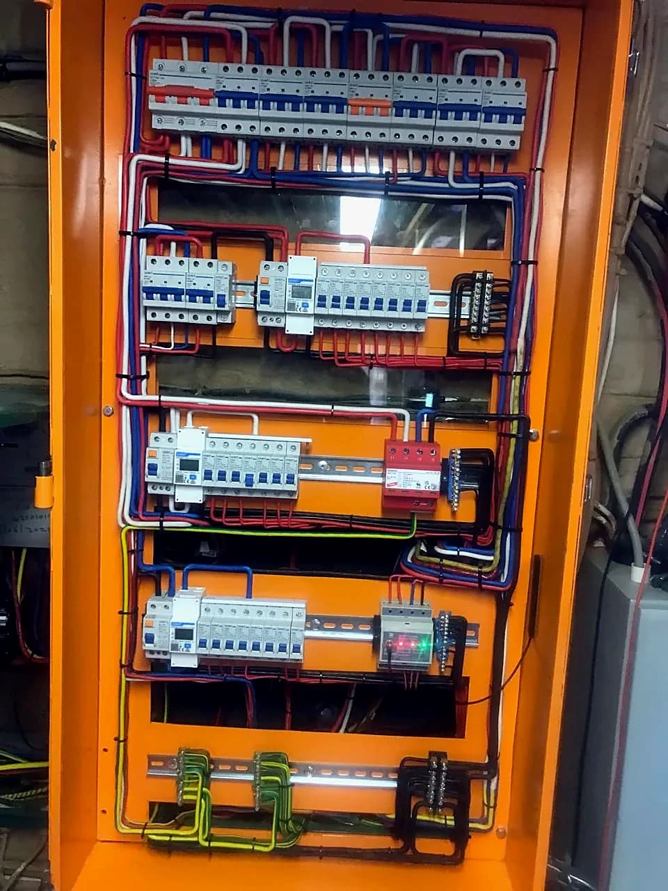 Completed distribution board rewire with breakers and labelled circuits in an orange enclosure