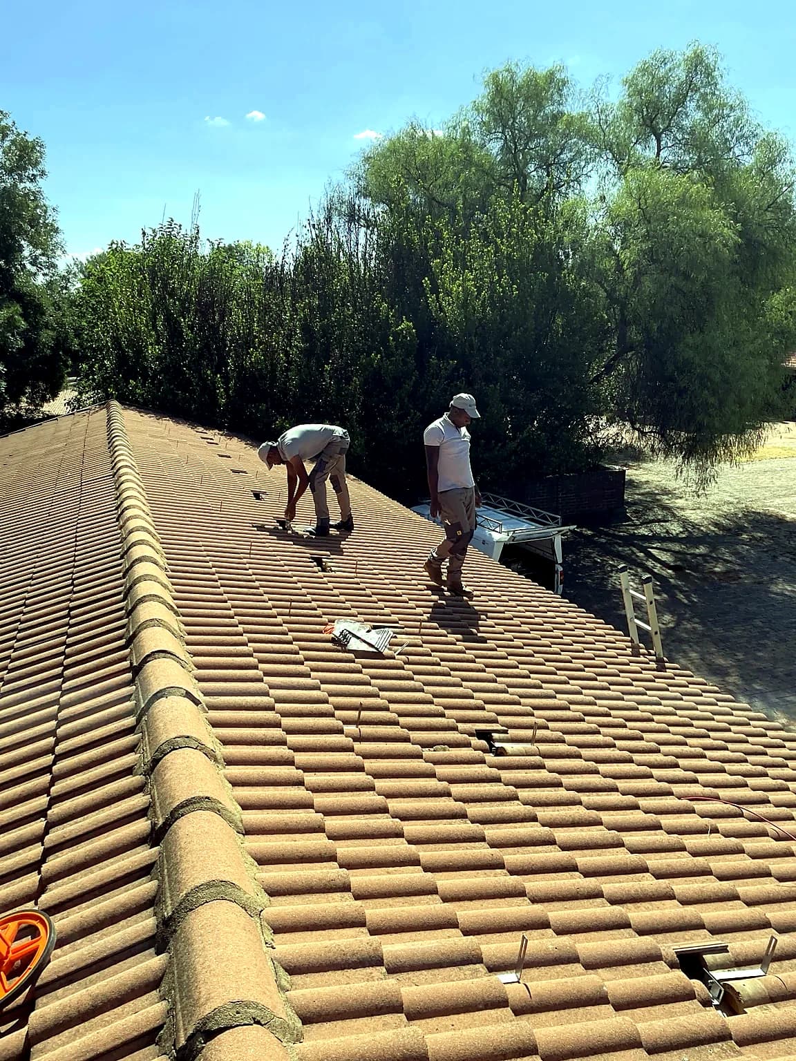 Solar installation in progress on a tiled roof